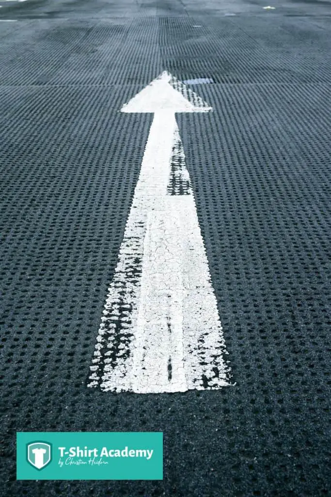 An arrow pointing upwards on the ground.